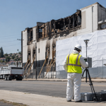 two workers assessing the damage of a warehouse fire