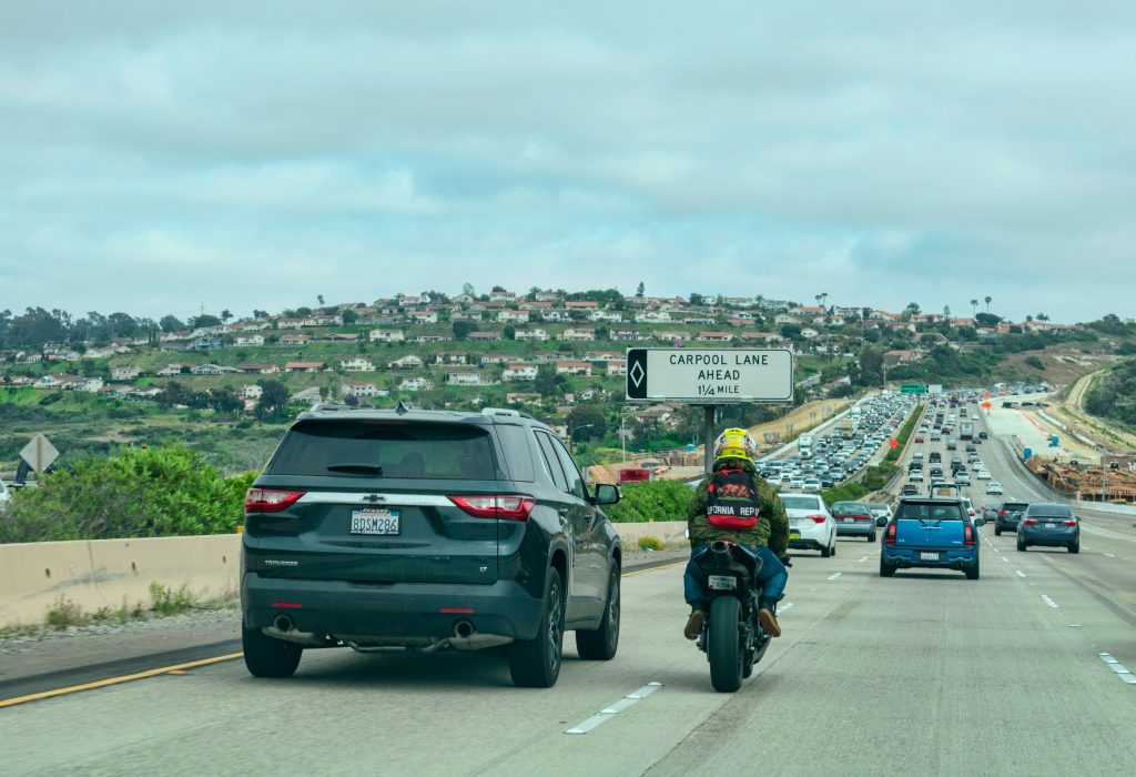 Motorcycle Rider Passing Car